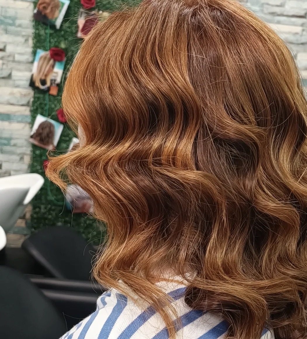 Riflessi ramati luminosi su capelli mossi